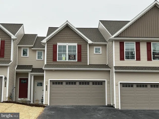 a front view of a house with garage
