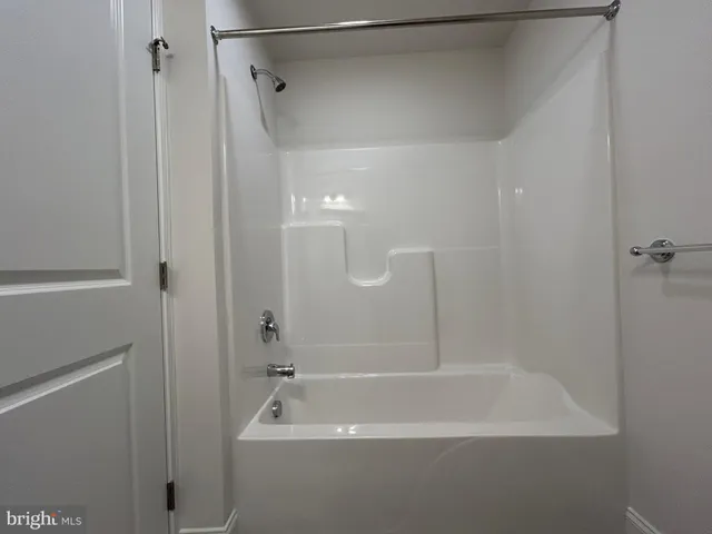 a bathroom with a shower and a bath tub