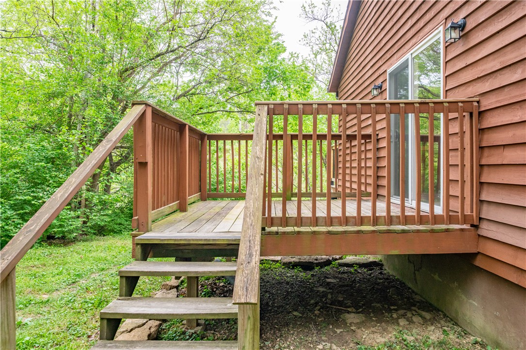 10584 New Biddinger Road Harrison, OH 45030 - Photo 53 of 61 This charming outdoor deck provides a serene escape surrounded by lush greenery.