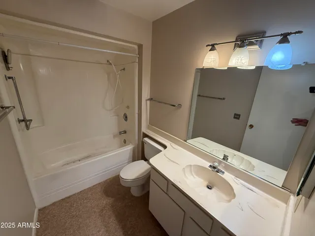 a bathroom with a sink toilet double vanity and tub