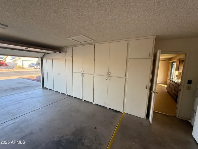 a view of empty room with wooden floor and natural light