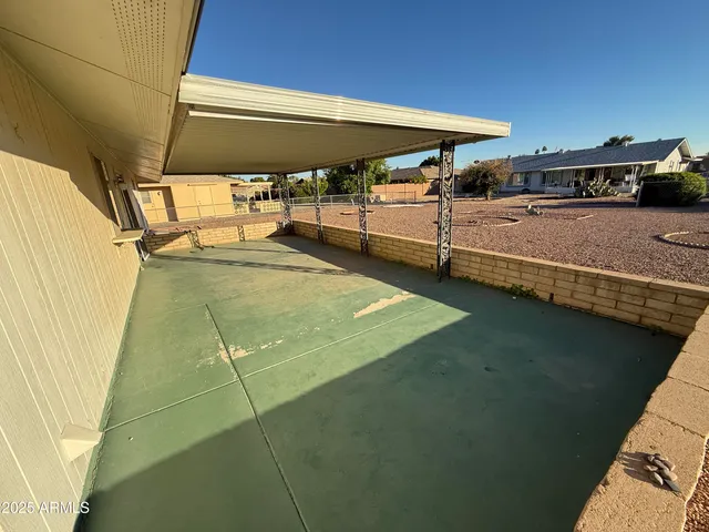 a backyard of a house with table and chairs