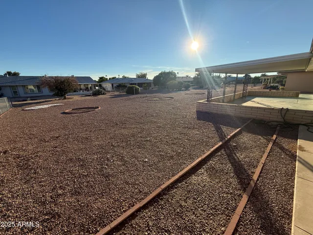 a terrace with a bench and trees