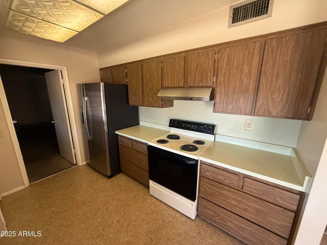 a kitchen with stainless steel appliances a refrigerator and a stove