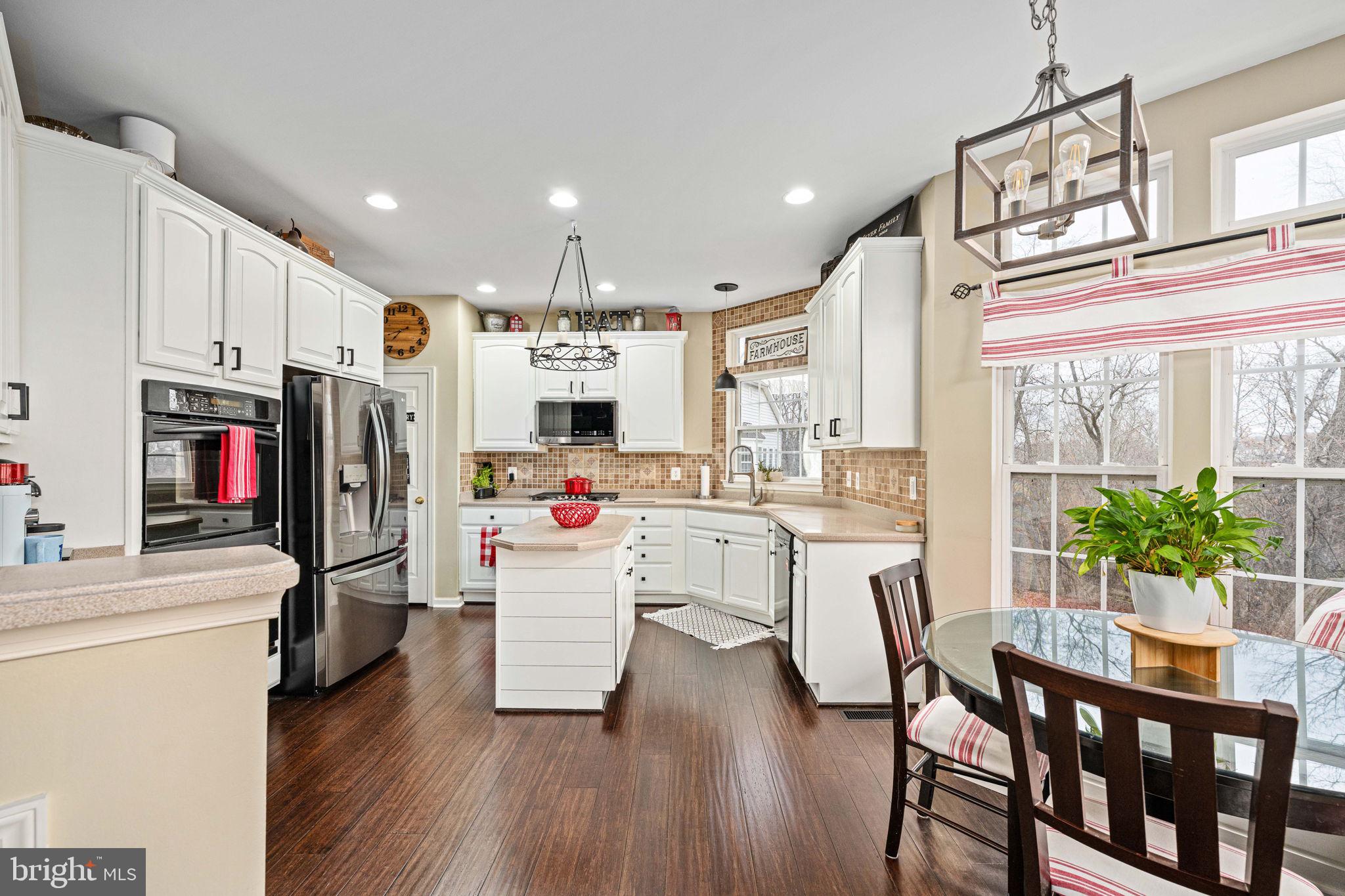 5505 Altenbury Loop Gainesville, VA 20155 - Photo 17 of 62 a kitchen that has a lot of cabinets a sink and appliances
