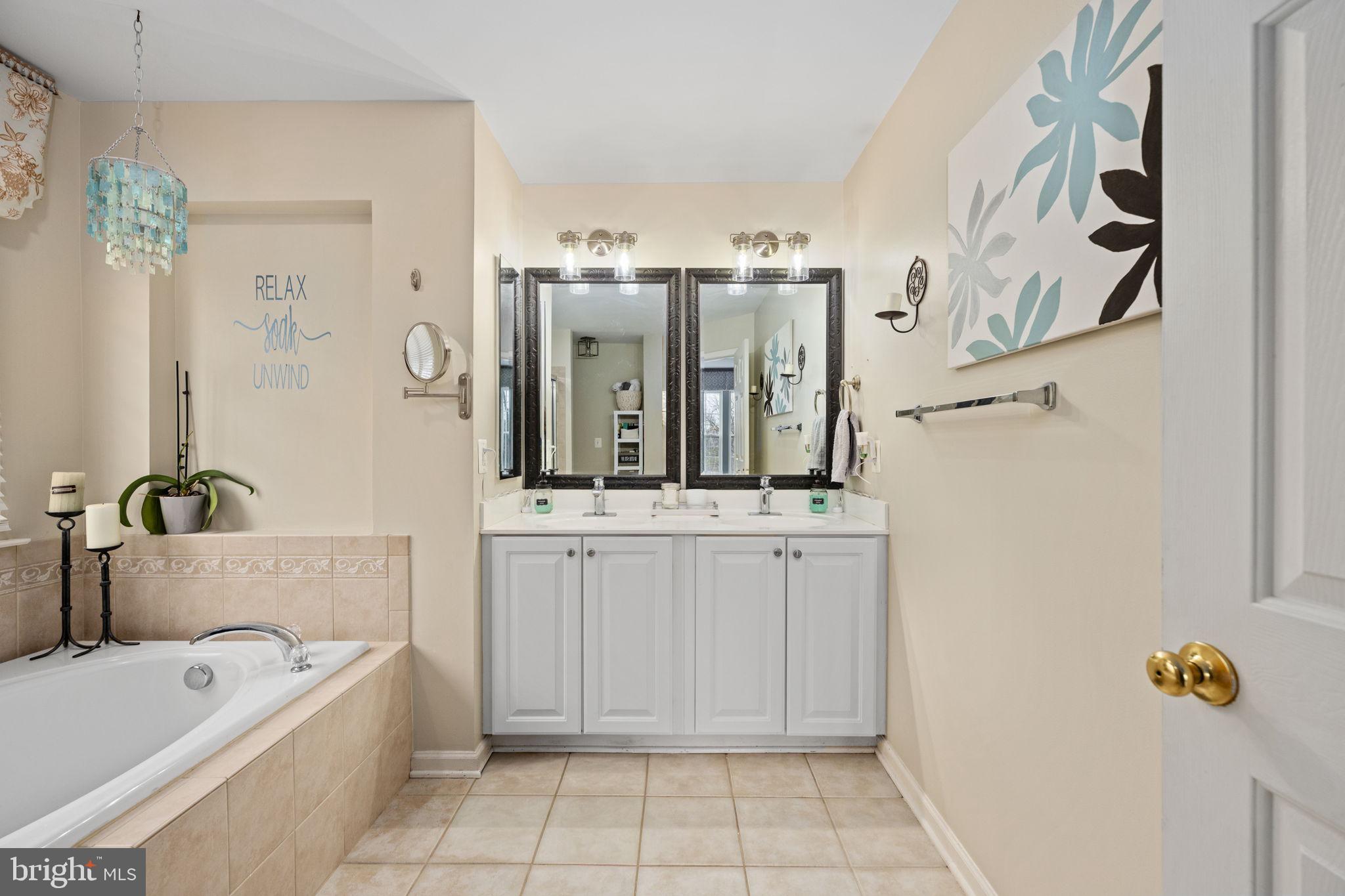 5505 Altenbury Loop Gainesville, VA 20155 - Photo 43 of 62 a bathroom with a tub a mirror and shower