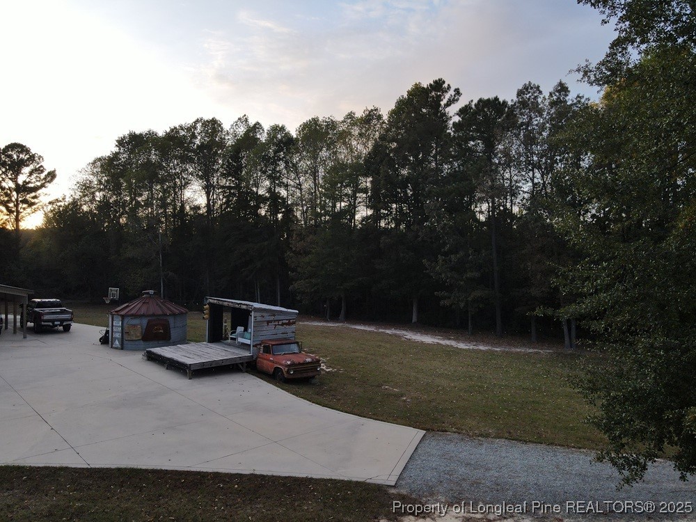 5671 Stewart Road Godwin, NC 28344 - Photo 17 of 34 a view of backyard with furniture and trees