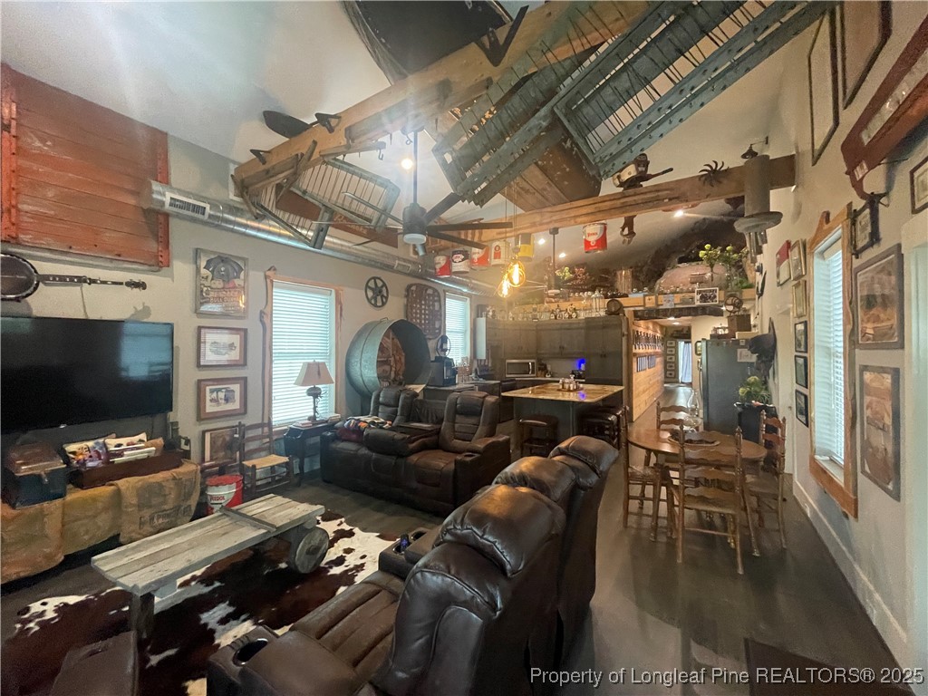 5671 Stewart Road Godwin, NC 28344 - Photo 18 of 34 a media room with lots of chairs and a flat screen tv