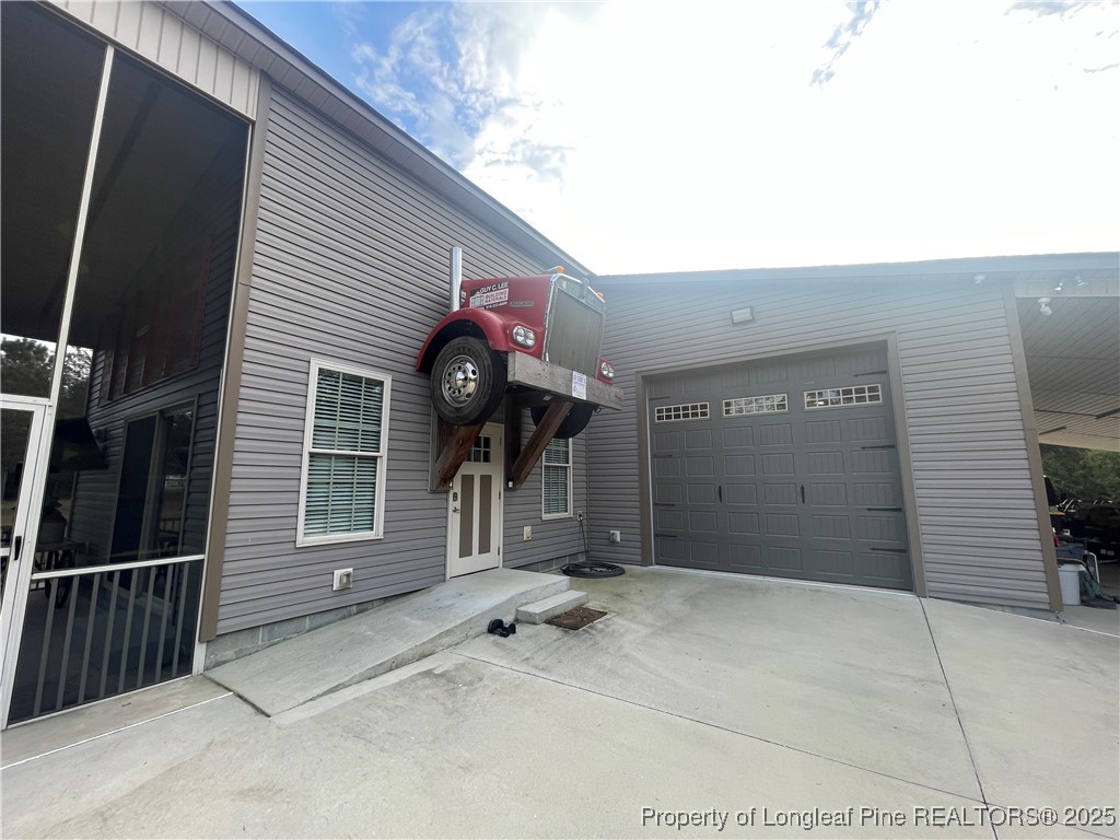 5671 Stewart Road Godwin, NC 28344 - Photo 31 of 34 a view of a house with a garage