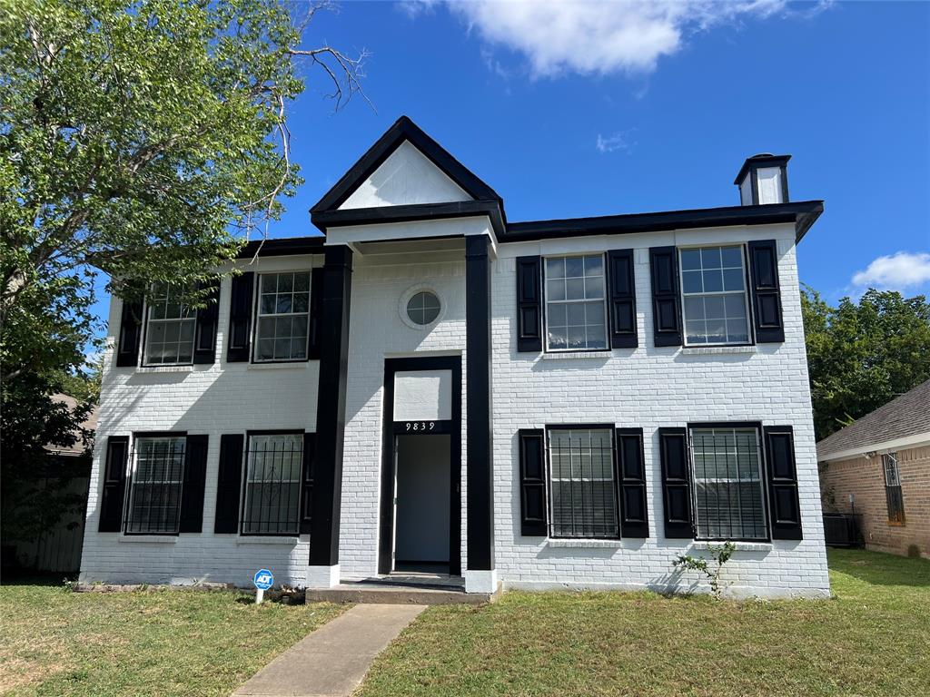 9839 Paramount Avenue Dallas, TX 75217 - Photo 1 of 1 a front view of a house with a yard