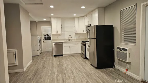 a kitchen with a refrigerator a sink and dishwasher