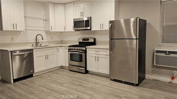 a kitchen with a refrigerator sink and microwave