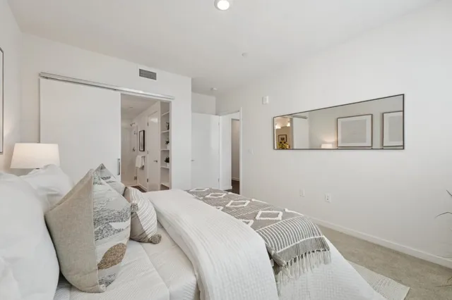 a bedroom with a bed and a lamp