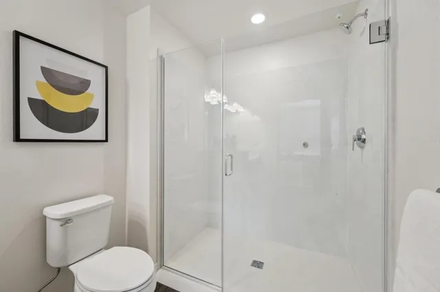 a bathroom with a toilet and a shower