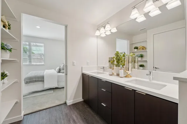 a spacious bathroom with a double vanity sink a mirror and a bathtub