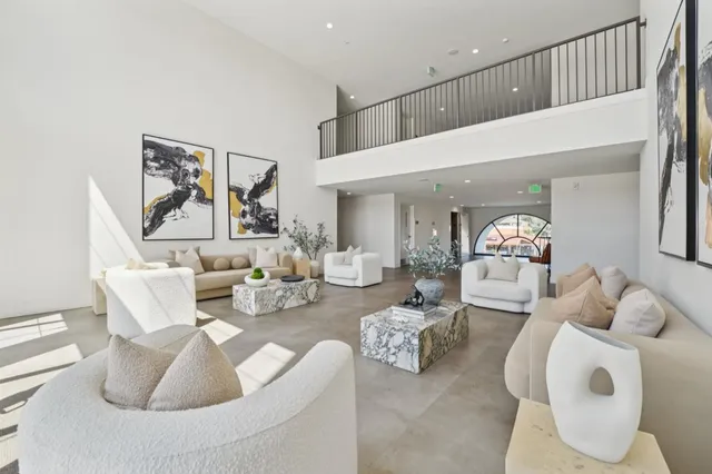 a living room with furniture and a painting on the wall