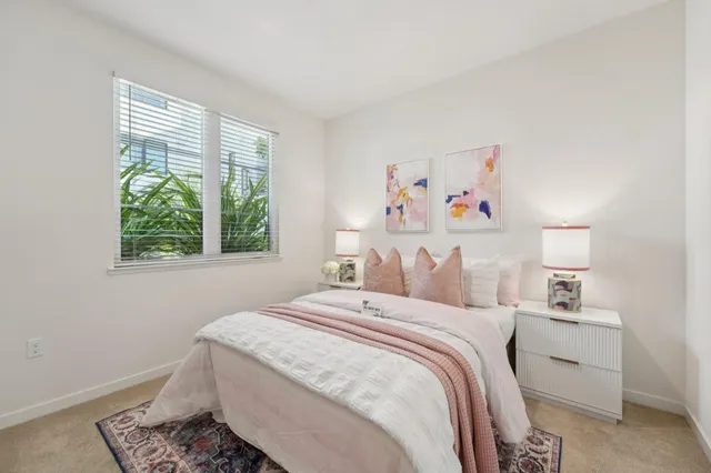 a bedroom with a bed and a painting on the wall