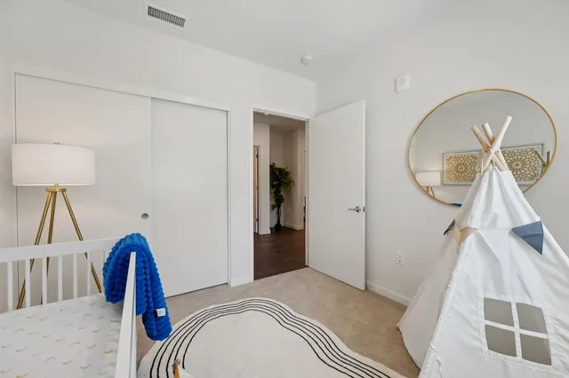 a view of a livingroom with wooden floor and a chandelier