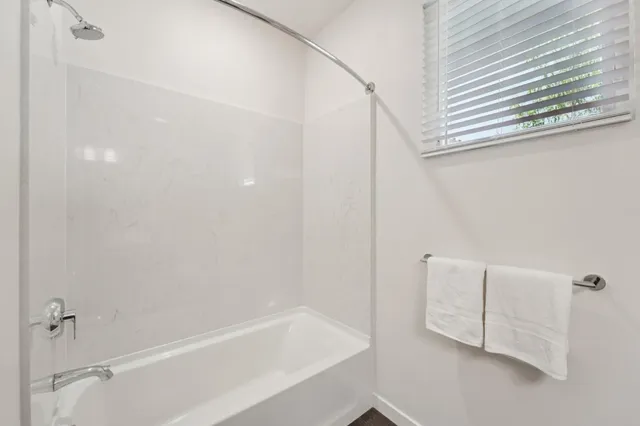 a bathroom with a bathtub and shower