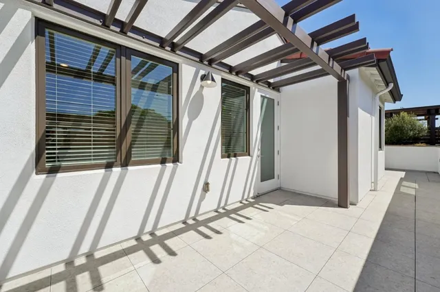 a view of a patio with couches and potted plants