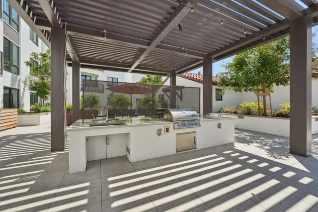a living room with furniture chess floor and a potted plant