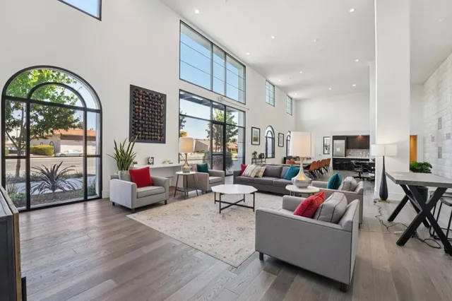 a view of a livingroom with furniture and floor to ceiling window