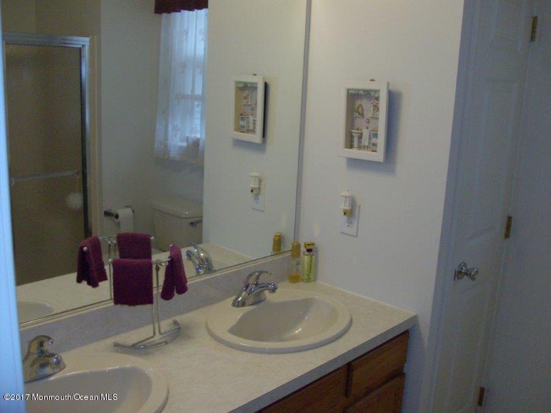 45 Tennyson Road Brick, NJ 08724 - Photo 14 of 23 a bathroom with a sink and a mirror