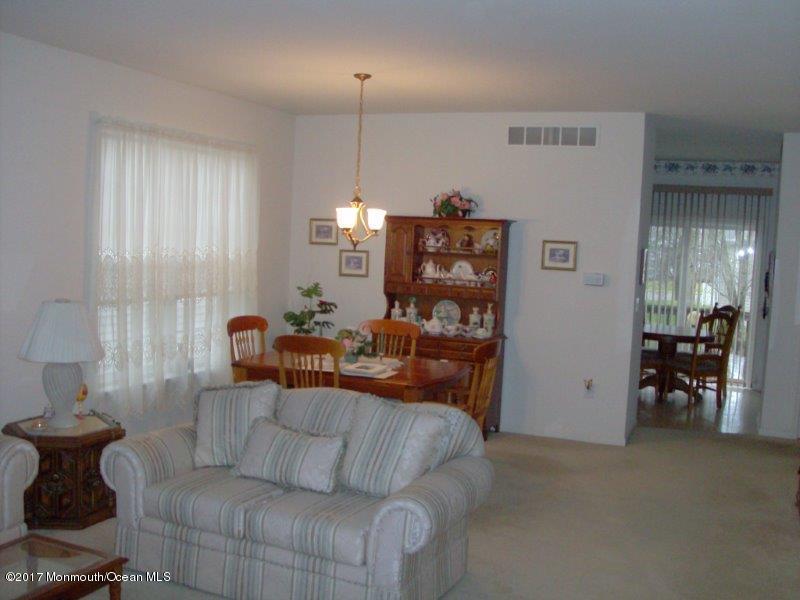 45 Tennyson Road Brick, NJ 08724 - Photo 4 of 23 a living room with furniture and a chandelier