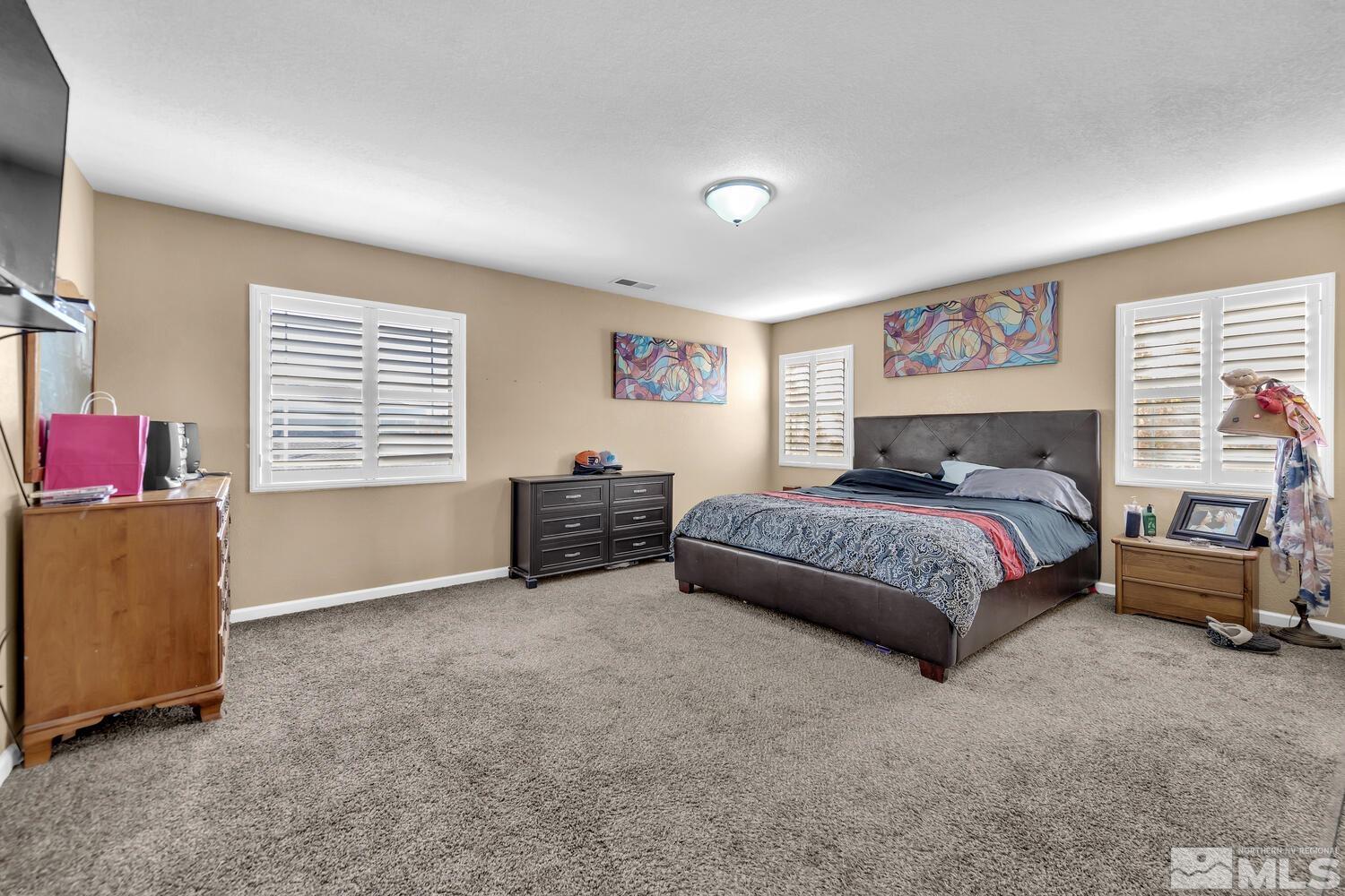 8970 Sorcha Street Reno, NV 89506 - Photo 21 of 38 a bedroom with a bed and a couch