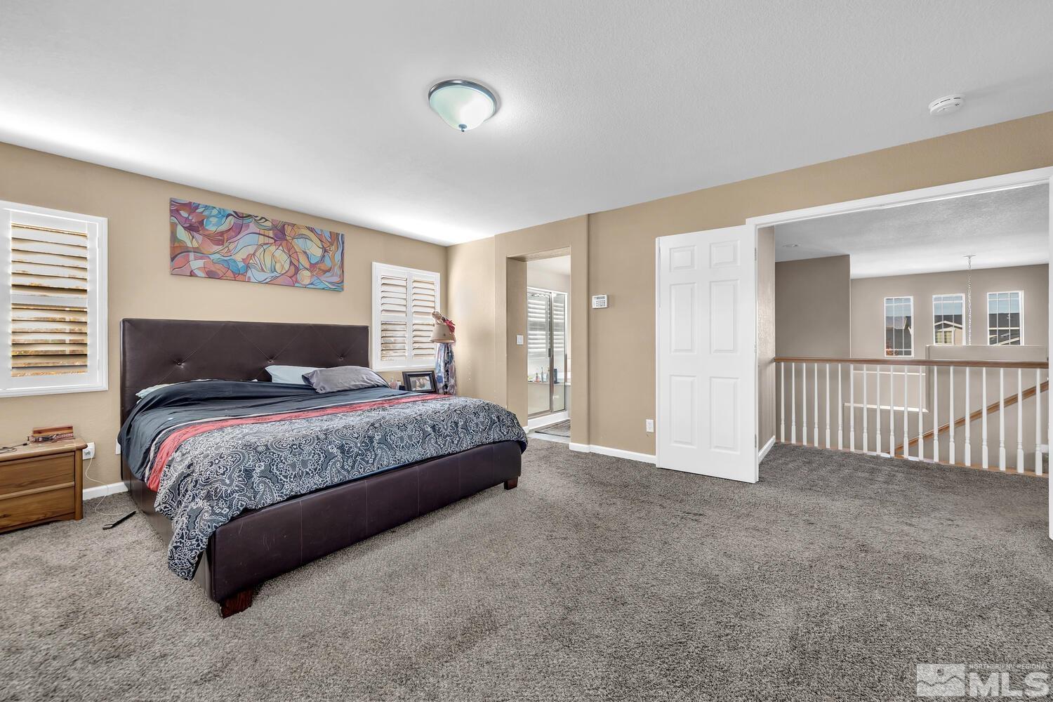 8970 Sorcha Street Reno, NV 89506 - Photo 22 of 38 a bedroom with a large bed and a window