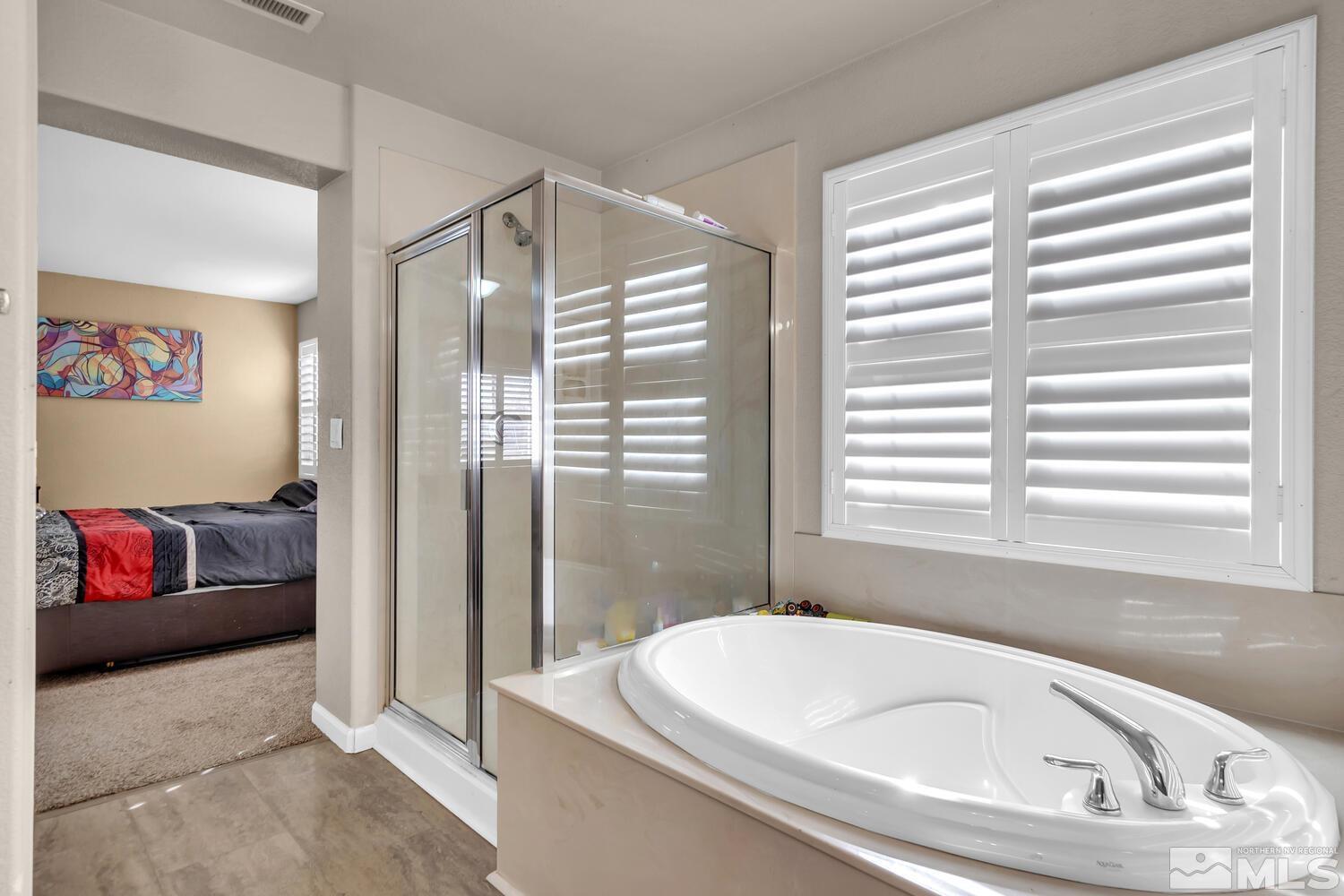 8970 Sorcha Street Reno, NV 89506 - Photo 24 of 38 a bathroom with bathtub and window