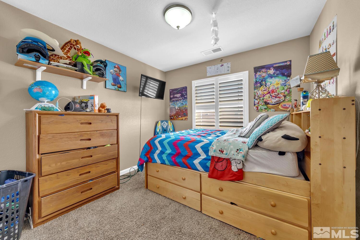 8970 Sorcha Street Reno, NV 89506 - Photo 28 of 38 a bedroom with a bed and a window