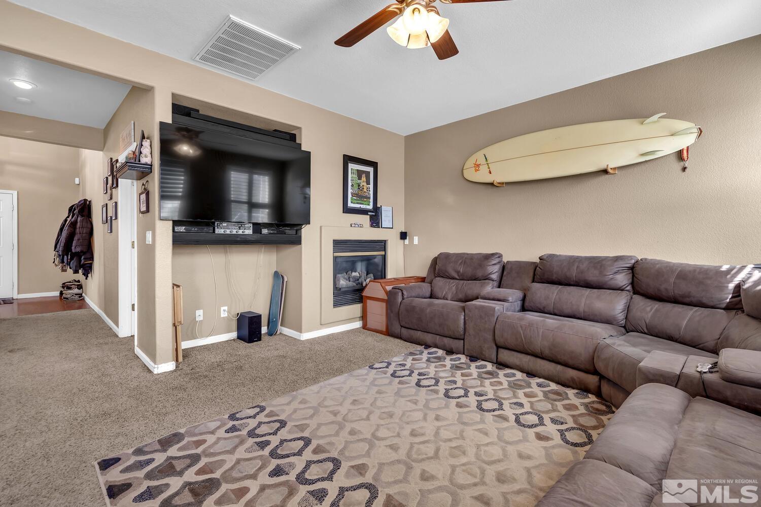 8970 Sorcha Street Reno, NV 89506 - Photo 3 of 38 a living room with furniture and a flat screen tv
