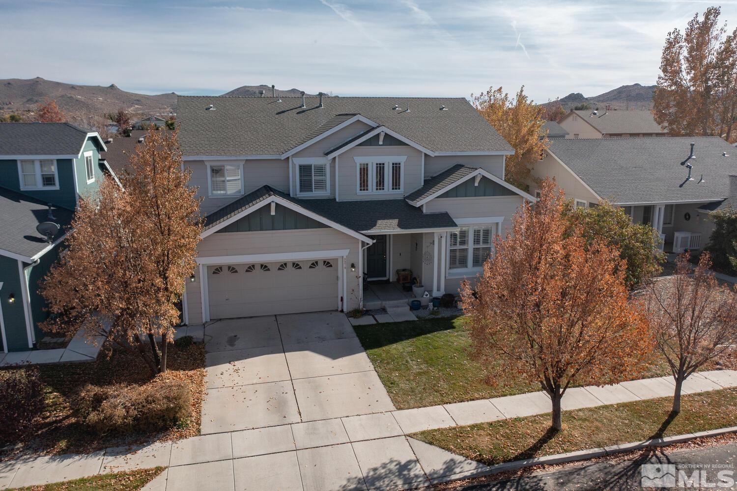 8970 Sorcha Street Reno, NV 89506 - Photo 33 of 38 a view of a white house next to a yard with big trees