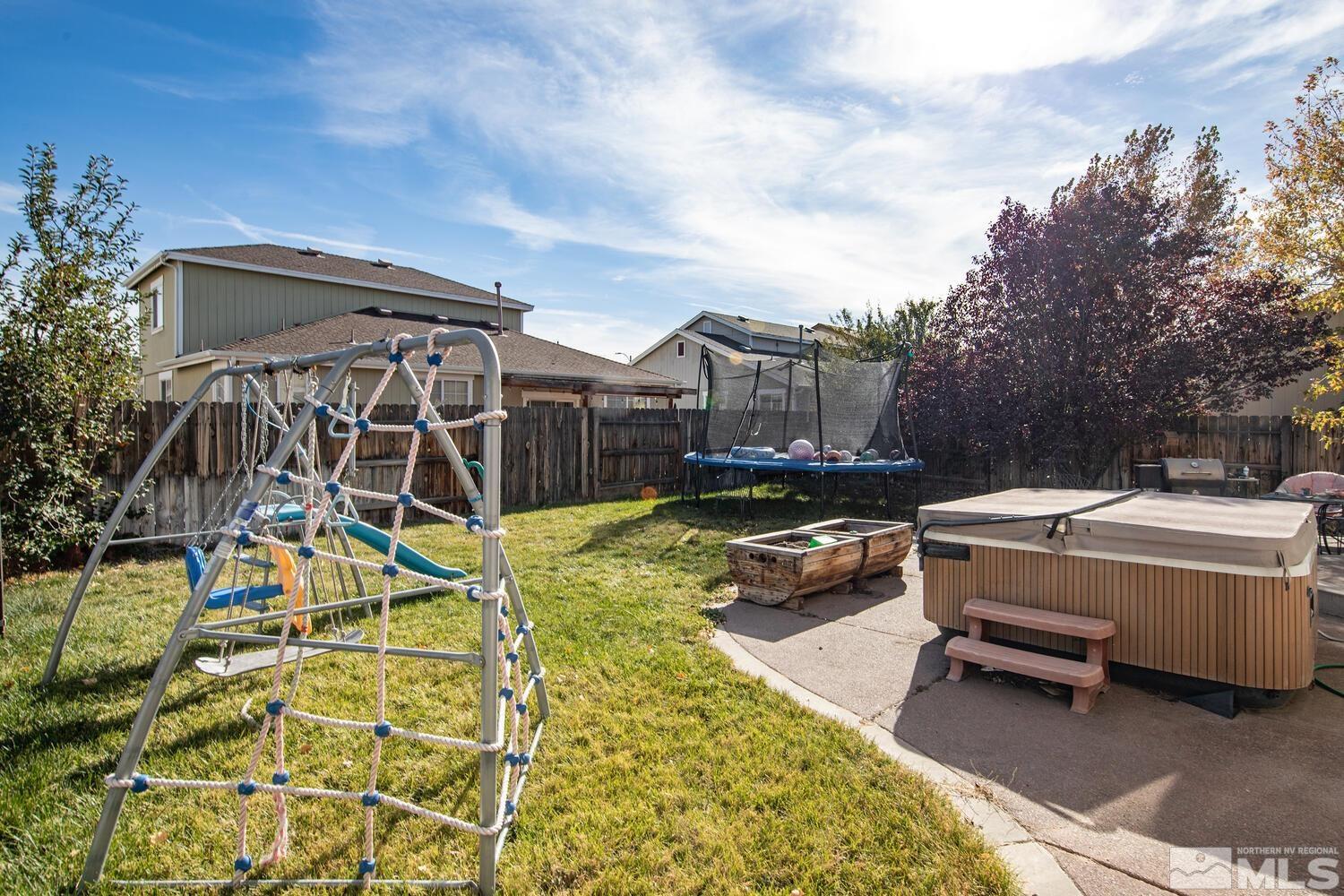 8970 Sorcha Street Reno, NV 89506 - Photo 35 of 38 a view of a swimming pool with a patio and a yard
