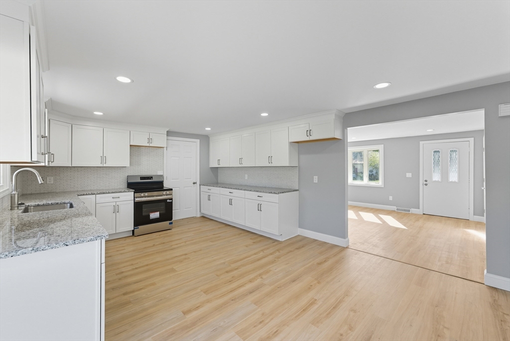87 Prokop Avenue Ludlow, MA 01056 - Photo 11 of 40 a large kitchen with stainless steel appliances granite countertop a stove a sink and a refrigerator