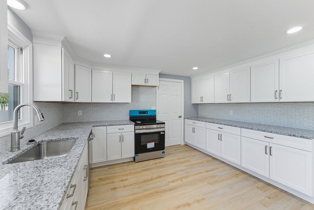 87 Prokop Avenue Ludlow, MA 01056 - Photo 12 of 40 a kitchen with granite countertop a sink stove and cabinets