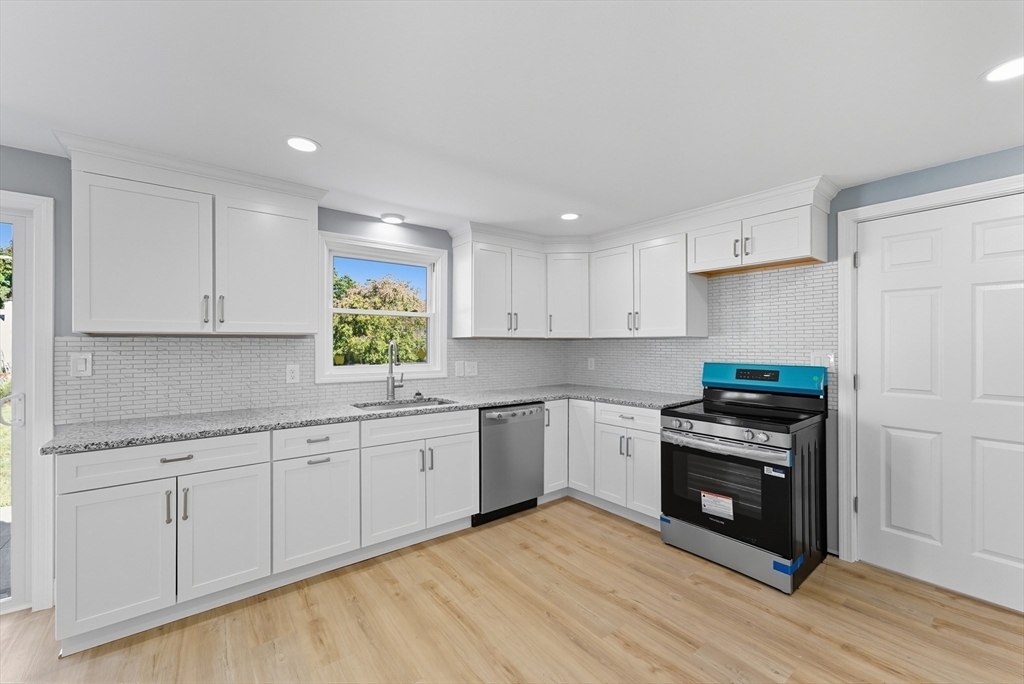 87 Prokop Avenue Ludlow, MA 01056 - Photo 13 of 40 a kitchen with stainless steel appliances granite countertop a stove and a sink
