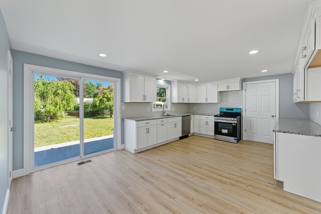 87 Prokop Avenue Ludlow, MA 01056 - Photo 15 of 40 a view of a kitchen with wooden floor and electronic appliances