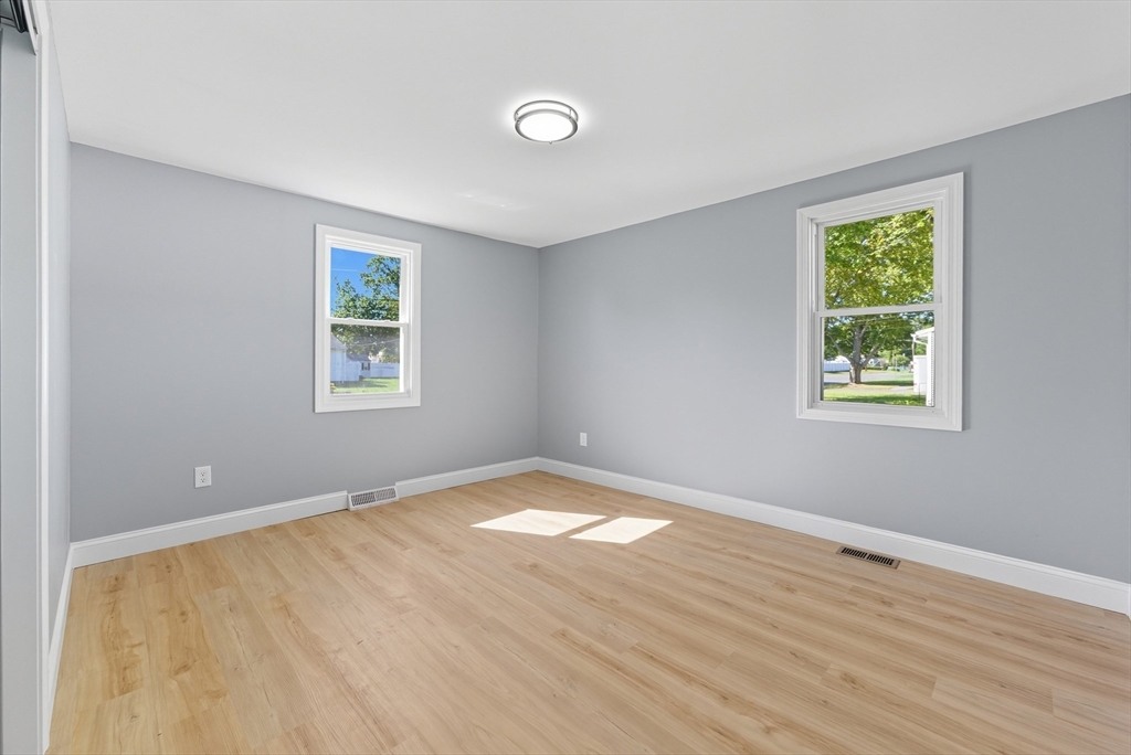 87 Prokop Avenue Ludlow, MA 01056 - Photo 21 of 40 a view of an empty room with a window and wooden floor