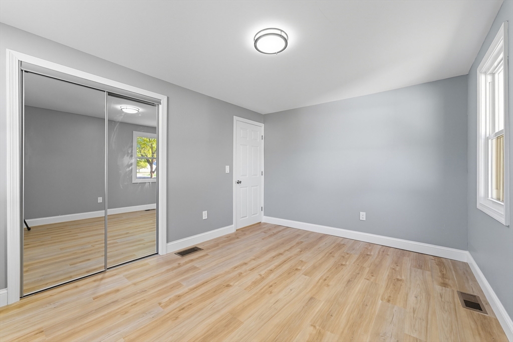 87 Prokop Avenue Ludlow, MA 01056 - Photo 26 of 40 an empty room with wooden floor and windows