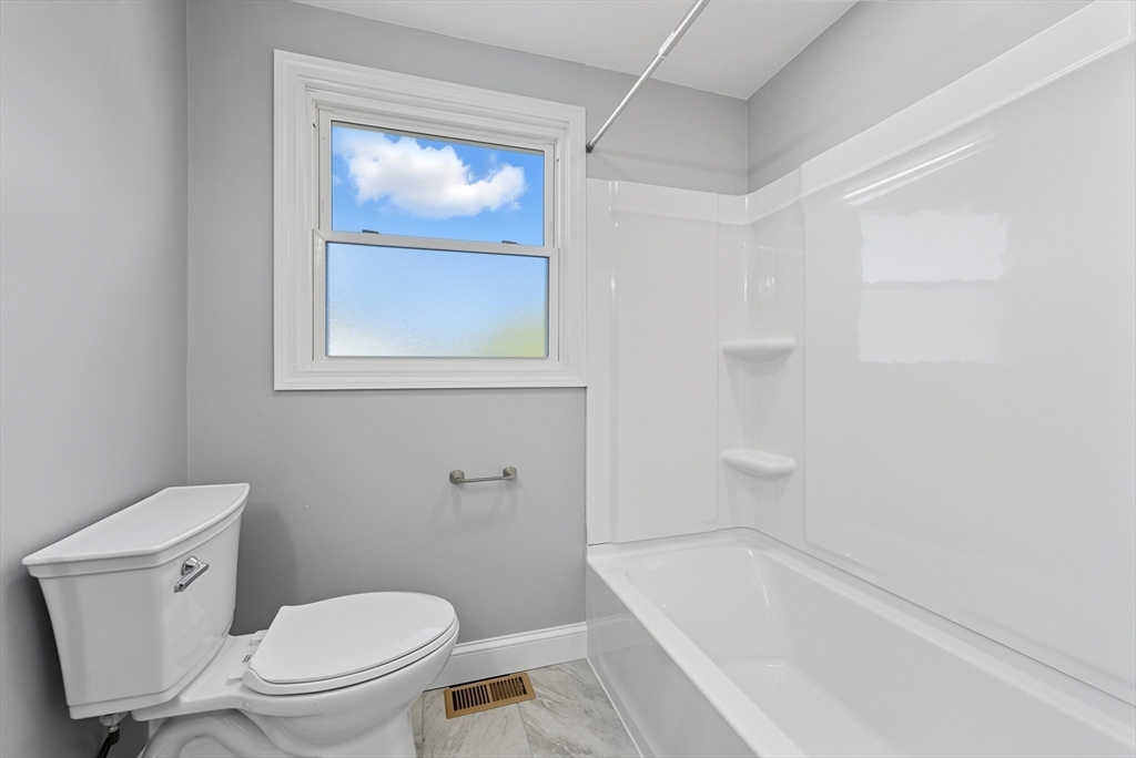 87 Prokop Avenue Ludlow, MA 01056 - Photo 28 of 40 a white toilet sitting next to a bath tub