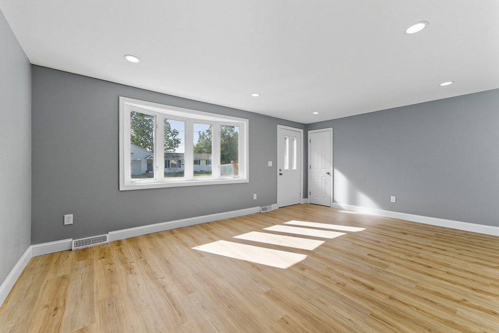 87 Prokop Avenue Ludlow, MA 01056 - Photo 7 of 40 a view of an empty room with wooden floor and a window