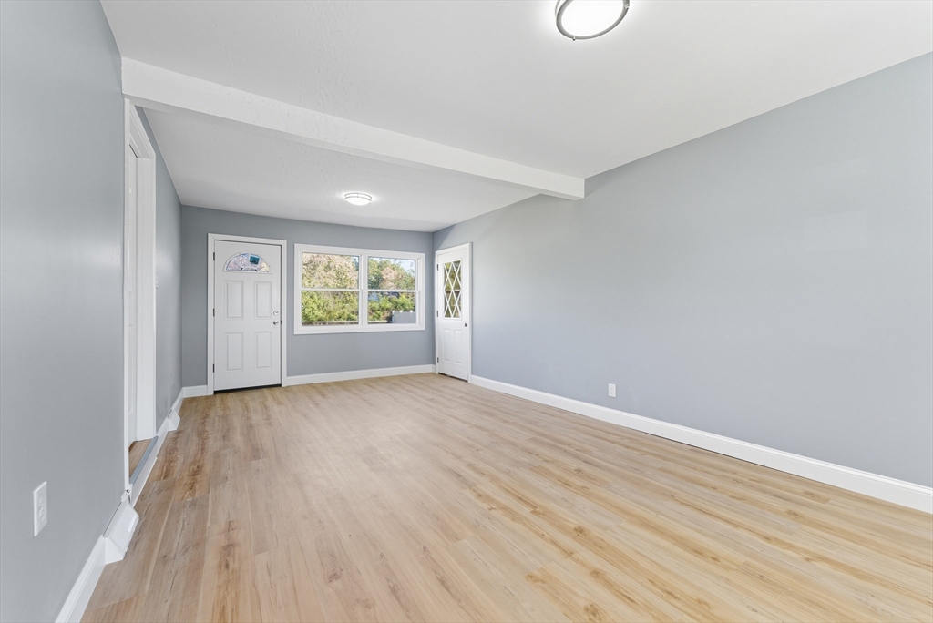 87 Prokop Avenue Ludlow, MA 01056 - Photo 8 of 40 a view of an empty room with window and wooden floor