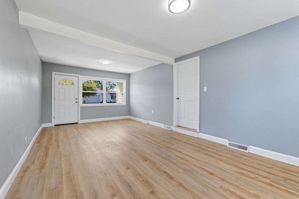 87 Prokop Avenue Ludlow, MA 01056 - Photo 9 of 40 a view of an empty room with a window and wooden floor