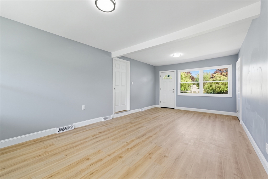 87 Prokop Avenue Ludlow, MA 01056 - Photo 10 of 40 a view of an empty room with wooden floor and a window