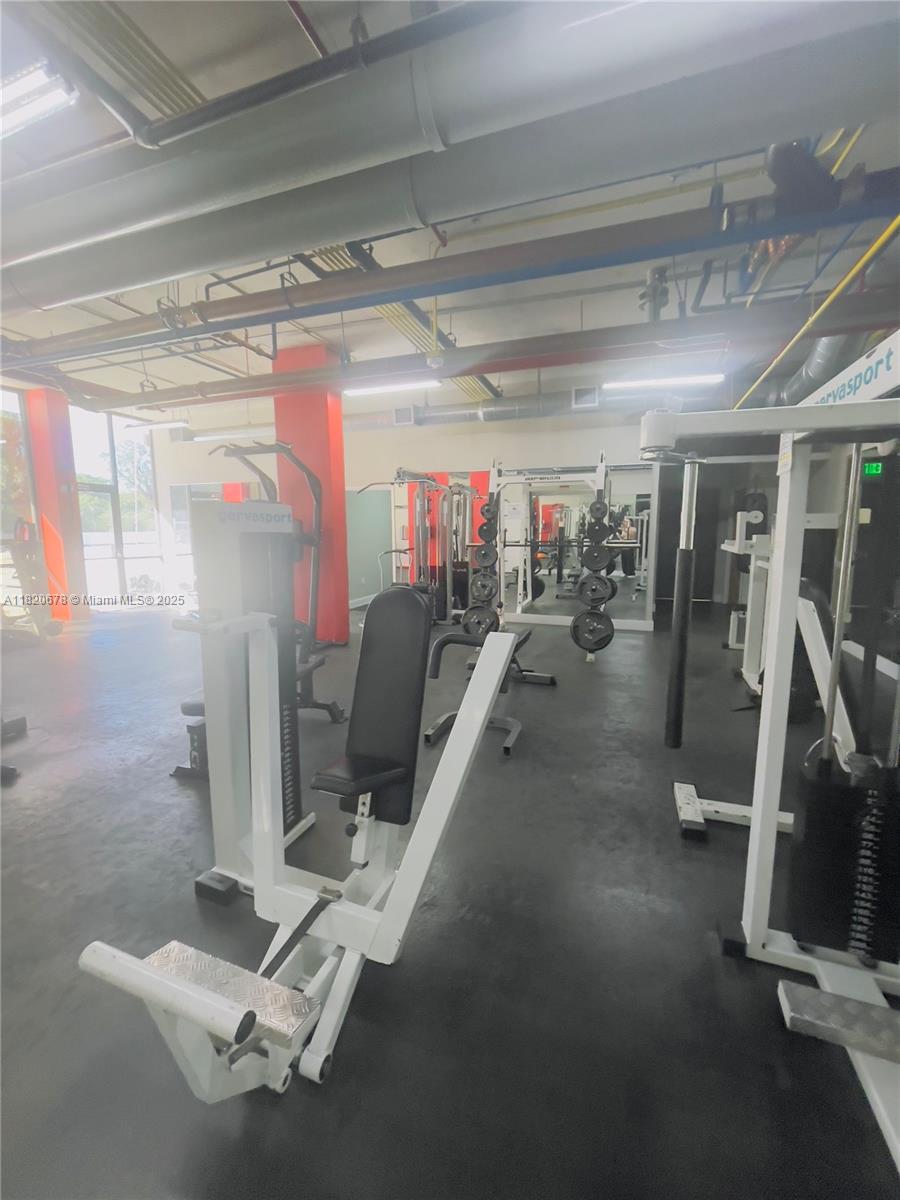780 Northeast 69th Street, Unit 1507 Miami, FL 33138 - Photo 19 of 23 a view of a room with gym equipment