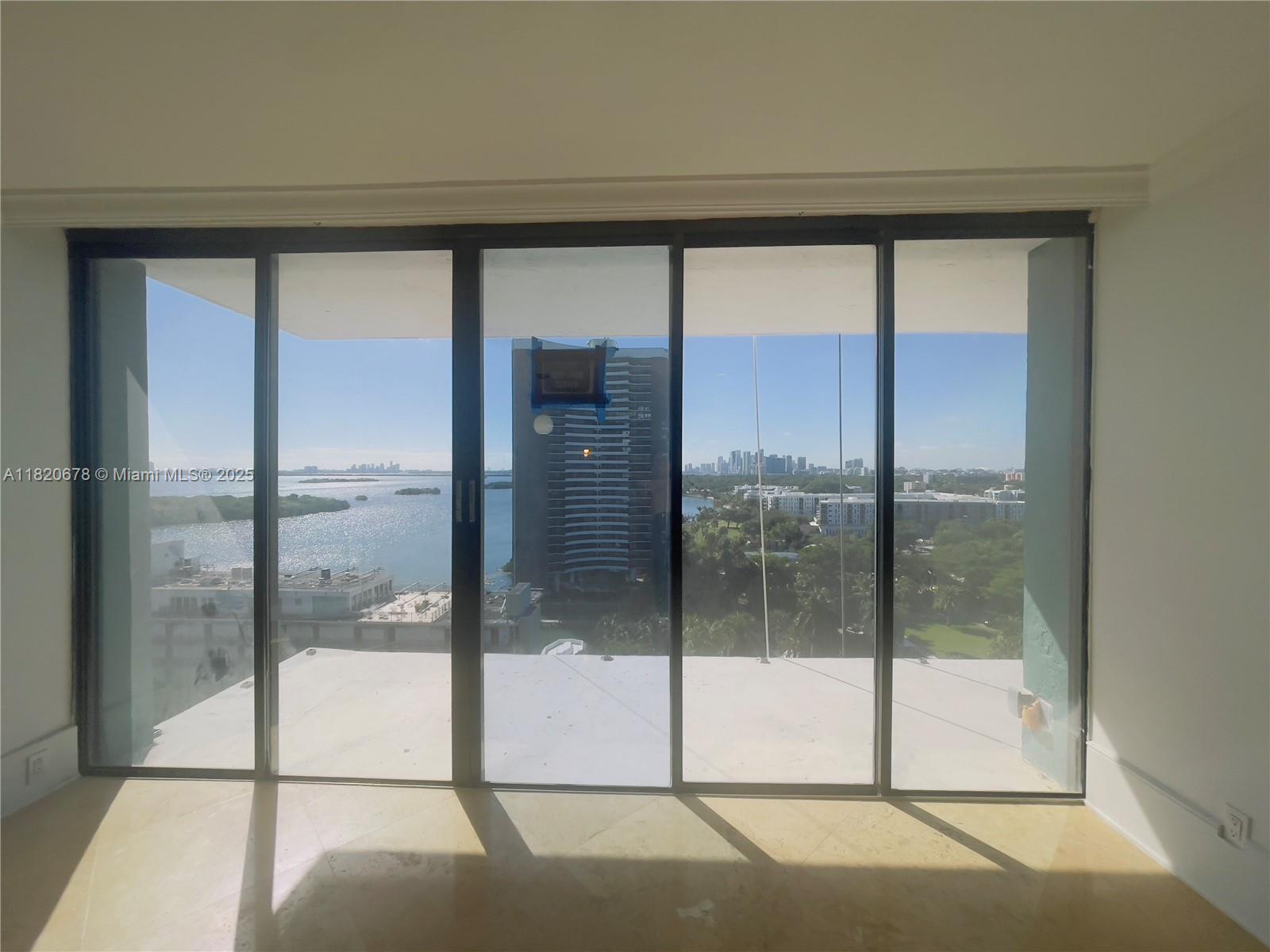 780 Northeast 69th Street, Unit 1507 Miami, FL 33138 - Photo 3 of 23 a view of a glass door of the house
