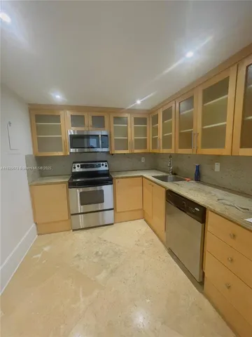 a kitchen with stainless steel appliances granite countertop a stove and a sink