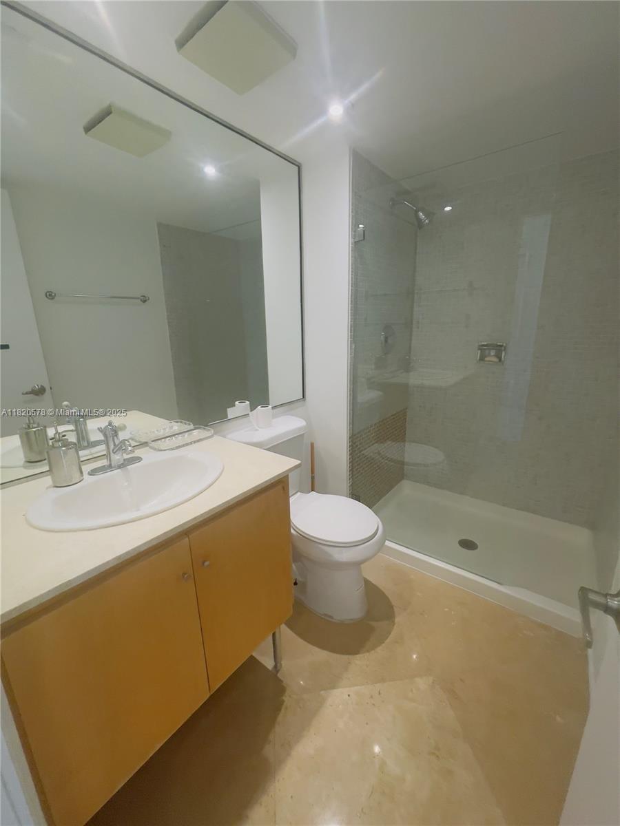 780 Northeast 69th Street, Unit 1507 Miami, FL 33138 - Photo 8 of 23 a bathroom with a sink a toilet and shower